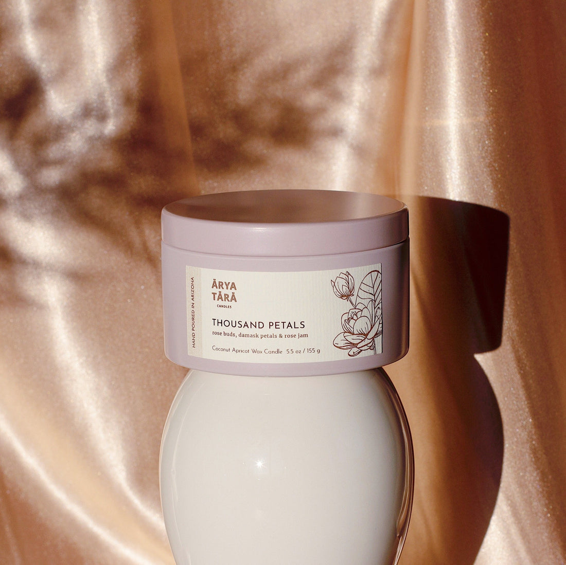 Thousand Petals Candle by Arya Tara Candles. Rose petal scent, floral fragrance. Rose buds, Damask rose petals, rose jam. Pink candle, pink candle jar. Rose oil candle, rose essential oil. Non-toxic natural candle made with coconut apricot wax, lead-free zinc-free wicks, premium fragrances. Luxury candle, natural candle. Made in Tucson Arizona, hand poured candle in small batch. Self care candle.