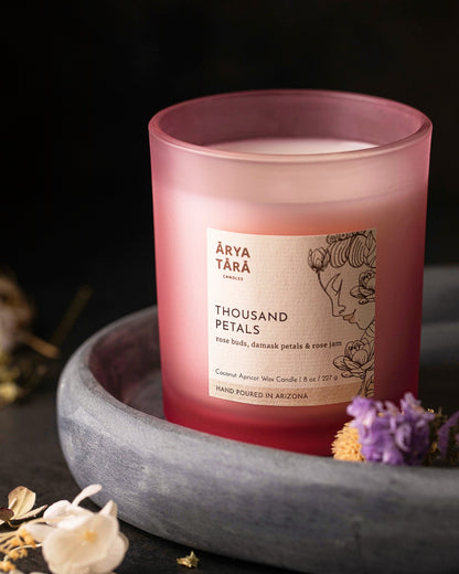 Thousand Petals Candle by Arya Tara Candles. Rose petal scent, floral fragrance. Rose buds, Damask rose petals, rose jam. Pink candle, pink candle jar. Rose oil candle, rose essential oil. Non-toxic natural candle made with coconut apricot wax, lead-free zinc-free wicks, premium fragrances. Luxury candle, natural candle. Made in Tucson Arizona, hand poured candle in small batch. Self care candle.