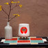 Ceramic wax warmer essential oil warmer by Arya Tara Candles. White outside red inside colored. Ceramic handmade tealight wax warmer with wooden legs.